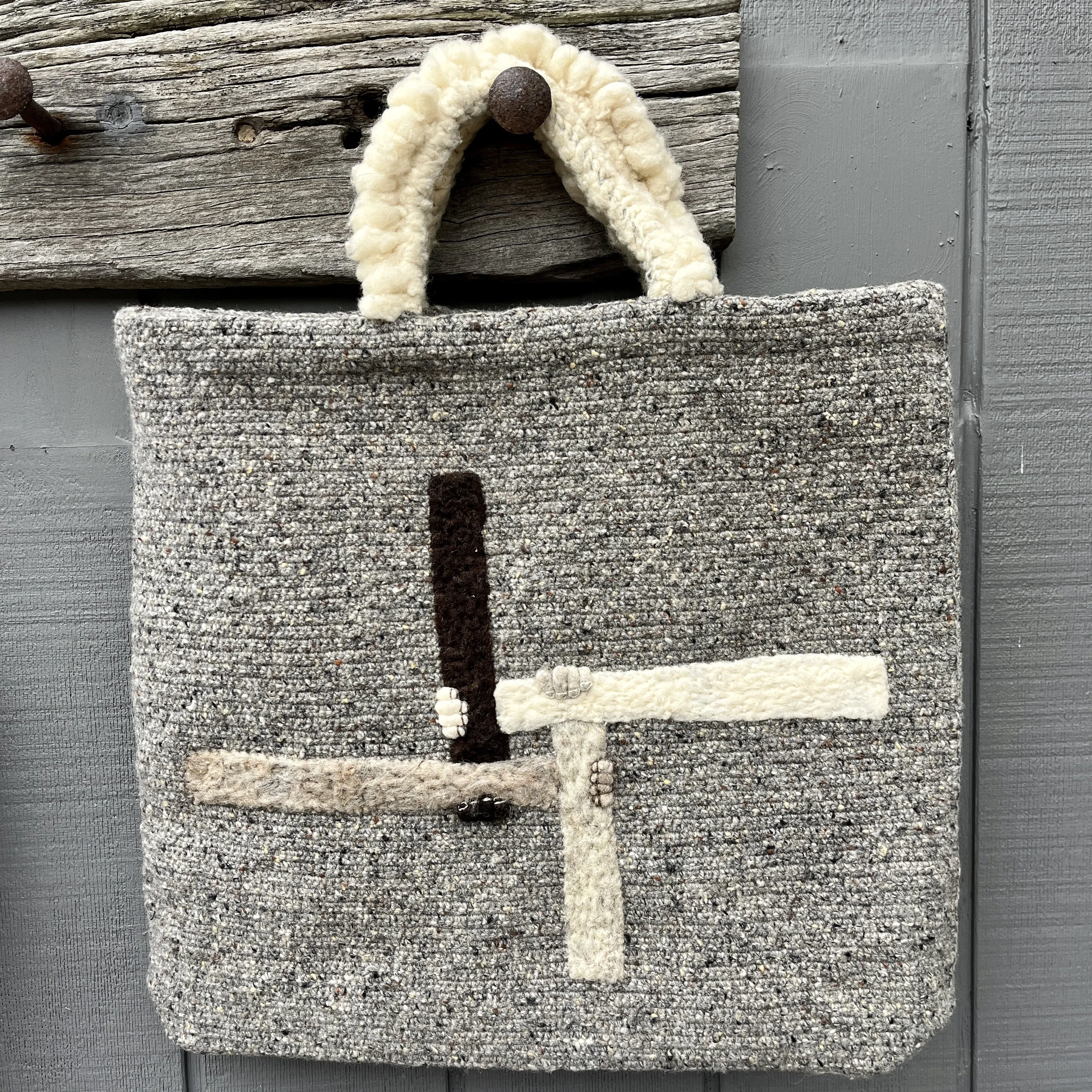 Grey wool crocheted tote bag with woolly handles